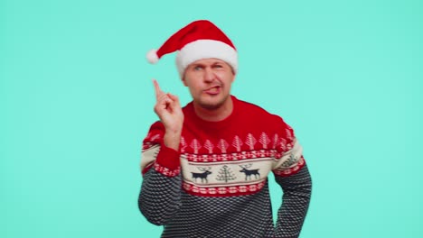 Displeased-man-in-Christmas-sweater-gesturing-hands-with-displeasure,-blaming-scolding-for-failure