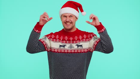 Cheerful-man-in-red-sweater-Christmas-Santa-shouting,-celebrating-success,-winning,-goal-achievemen