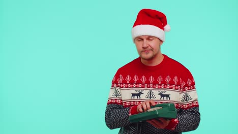 Funny-man-in-Christmas-sweater-talking-on-wired-vintage-telephone-of-80s,-says-hey-you-call-me-back