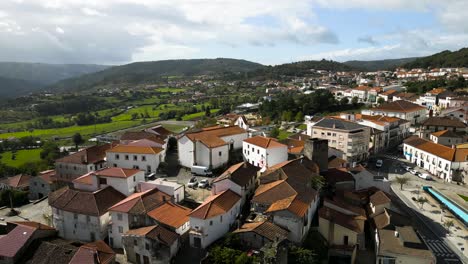 Drone-pullback-above-orange-roof-castle-and-town-of-Vinhais,-Braganza,-Portugal