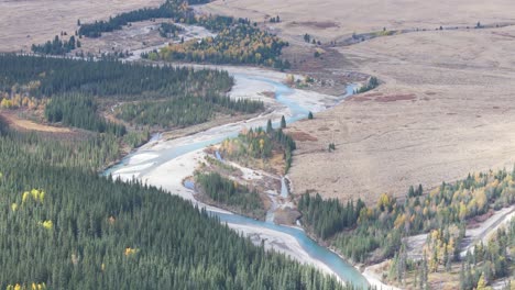 The-meandering-Red-Deer-River-in-Ya-Ha-Tinda-valley-of-Alberta-Canada-is-seen-from-an-aerial-drone-flying-upriver