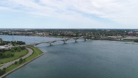 Drone-captures-a-stable-shot-of-the-Fort-Erie-Peace-Bridge,-with-cars-travelling-to-and-from-Fort-Erie-to-Buffalo
