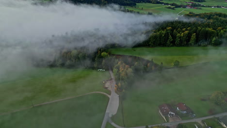 Aerial-view-of-foggy-green-rural-field-landscape