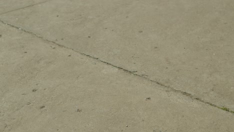 Close-shot-of-a-soccer-player-kicking-the-ball-on-cement