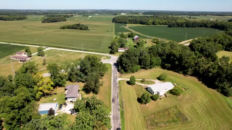 Midwest-countryside--aerial-fly-over-with-roads,-houses-and-farm-fields