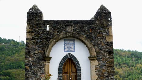Tilt-up-along-sacred-church-castle-entrance-in-Vinhais,-Braganza,-Portugal