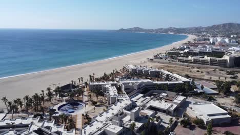 San-Jose-del-Cabo,-Mexico-panning-aerial-footage-view-of-resort-city-on-the-Baja-California-peninsula,-drone-shots-oceanfront-properties-and-clear-ocean-blue-waters