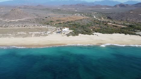 Aerial-view-of-Playa-Hotel-San-Cristobal-Todos-Santos-Baja-California-Sur,-drone-footage-of-clear-blue-ocean-waters-and-white-sandy-beaches