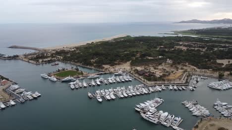 Wide-panning-aerial-footage-of-the-marina-near-San-Jose-del-Cabo-in-Los-Cabos-Mexico-with-boats-docked-in-harbor