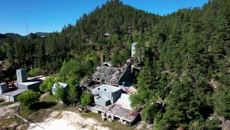Abandoned-Gold-Mine-Ruins-in-the-Black-Hills-of-South-Dakota--aerial-rotating-View