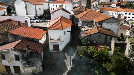 Quaint-orange-roof-castle-and-town-in-Vinhais,-Braganza,-Portugal,-aerial-establish