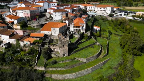 Drone-descends-to-promenade-grass-lawn-walls-in-Vinhais,-Braganza,-Portugal