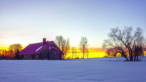 Timelapse-of-a-sunrise-in-a-winter-scene-with-a-cabin-in-the-outdoors