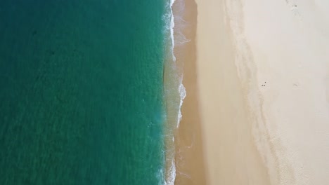 Downward-angle-drone-shot-of-clear-ocean-waters-at-Playa-El-Suspiro-Cabo-San-Lucas