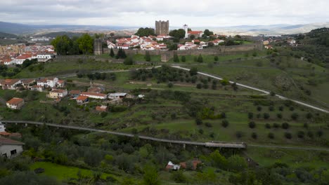 Aerial-dolly-over-ridgeline-to-medieval-castle-in-historic-center-of-Braganza-Portugal
