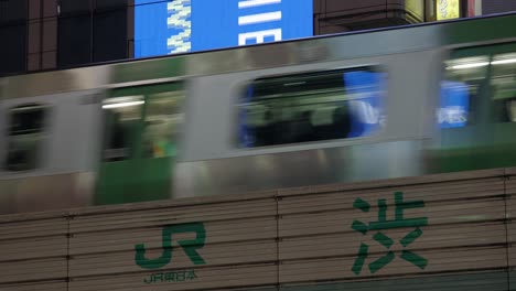 JR-Line-Metro-Railway-in-Shibuya-and-Advertisement-Billboards,-Tokyo,-Japan