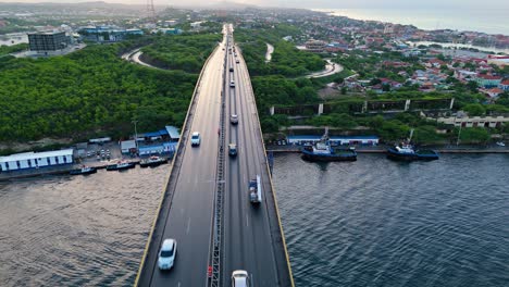 Aerial-dolly-above-cars-driving-across-Queen-Juliana-bridge-in-Willemstad-Curacao