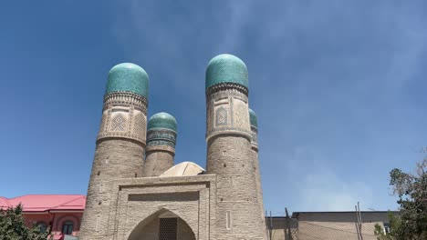 Chor-Minor,-Bukhara,-Uzbekistan:-4K-footage-of-a-19th-century-architectural-gem-representing-cultural-diversity-amidst-Bukhara's-UNESCO-streets,-echoing-the-city's-Silk-Road-history