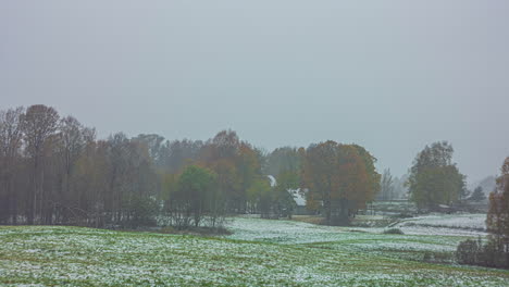 Time-lapse-of-a-vibrant,-sunny,-fall-day-turning-to-a-snowstorm-landscape
