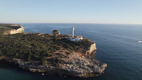 Luftaufnahme-Des-Leuchtturms-Ponta-Do-Altar-Am-Rand-Einer-Klippe-In-Ferragudo,-Portugal