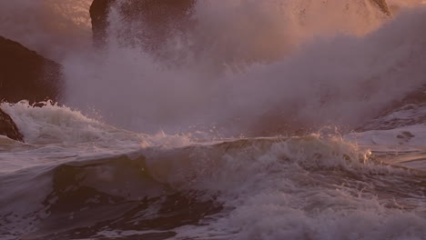Ocean-Waves-Breaking-Against-Rocks-At-Sunset-Beach