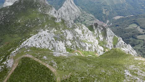 Impressive-view-from-a-drone-in-Picos-de-Europa,-Asturias,-with-roads-winding-through-the-mountains