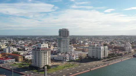 Aerial-panoramic-of-the-coastal-city-of-Veracruz,-Mexico,-displays-a-harmonious-blend-of-modern-high-rises-and-historic-architecture-along-the-seaside