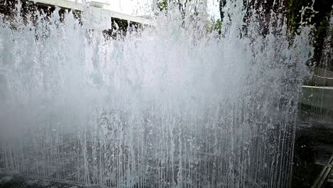 Slow-motion-of-a-water-fountain-situated-in-the-middle-of-a-community-mall-in-Bangkok,-Thailand