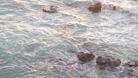 ocean,-sunset,-rocks-in-the-water,-waves-hitting-the-rocks