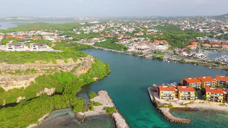 Vista-royal-and-Caracasbaai-neighborhood-with-beach-resort-and-marina-below-cliffs-in-Curacao