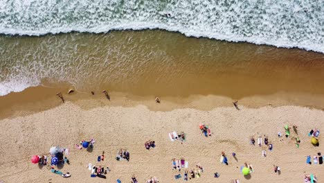 top-down-drone-shot-of-a-busy-beach-in-Hossegor,-France