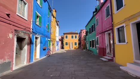 4K-Gimbal-Shot-Revealing-the-Enchanting-Charm-of-Burano-Island,-Venice-Italy:-Narrow-and-Colorful-Streets-Lined-with-Unique-Architectural-Styles,-Capturing-the-Vibrant-Ambience-and-Atmosphere