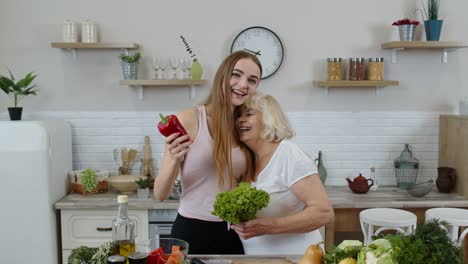 Senior-grandmother-with-granddaughter-recommending-eating-raw-vegetable-food.-Vegetable-diet