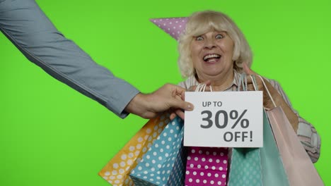 Advertisement-Up-To-30-Percent-Off-appears-next-to-grandmother.-Woman-dancing-with-shopping-bags