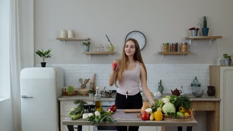 Pretty-young-girl-coming-to-the-table-with-juicy-apple.-Cutting-with-knife-and-eating-fresh-fruit
