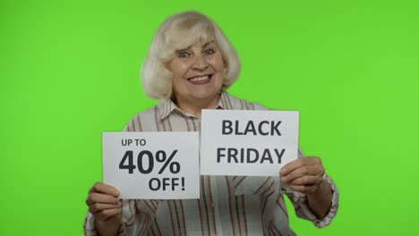 Senior-grandmother-showing-Black-Friday,-40-Percent-Off-discount-advertisement-inscriptions