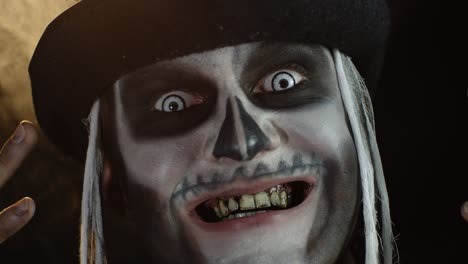 Man-in-skeleton-Halloween-cosplay-costume.-Guy-in-creepy-skull-makeup-looking-wide-open-eyes