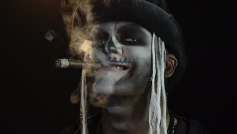 Frightening-man-in-skeleton-Halloween-cosplay-costume-smoking-cigar,-making-faces,-smiling
