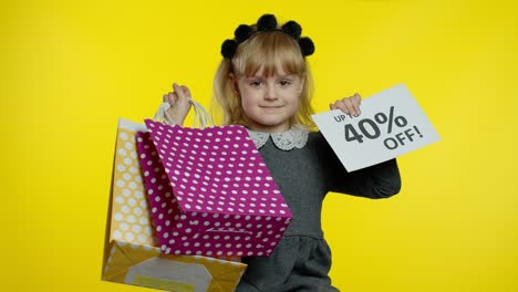 Child-girl-showing-Up-To-40-percent-Off-inscription-sign-and-shopping-bags.-Teen-pupil-smiling