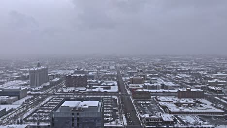 Aerial-trucking-shot-of-snow-covered-downtown-Salt-Lake-City-Utah-on-gloomy-day