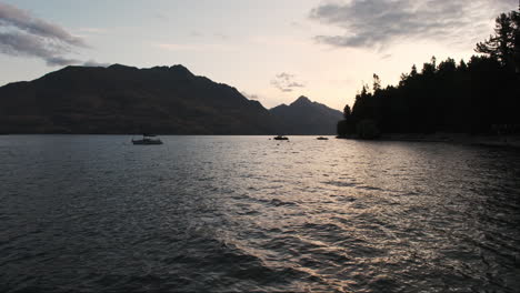 Sailboats-gently-sway-in-the-tranquil-waters-of-Queenstown-as-the-sun-sets
