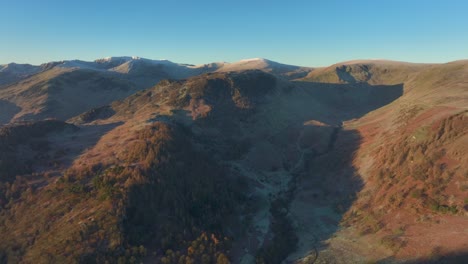 Mountains-bathed-in-early-morning-sunshine-with-slow-pan-revealing-range