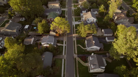 Aerial-over-nice-suburban-street-with-middle-class-houses-at-golden-hour