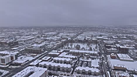 Snow-covered-winter-cityscape-aerial-view-of-downtown-Salt-Lake-City,-Utah