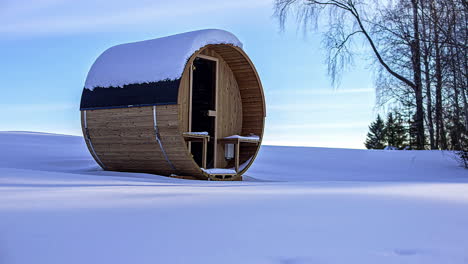 A-Portable-Standalone-Woodhouse-In-The-Middle-Of-A-Clear-Snowy-Ground-And-A-Sunset-Time-Lapse