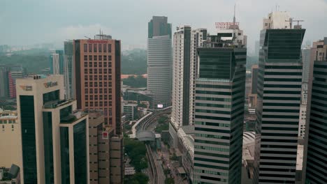 High-aerial-view-over-the-skyscrapers-of-downtown-Kuala-Lumpur,-Malaysia