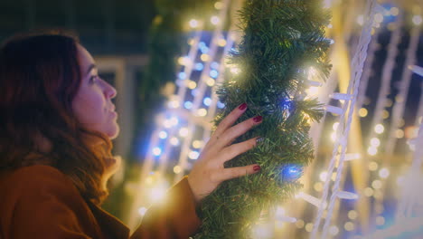 girl-enjoys-the-beautiful-Christmas-lights-close-slow-motion-shot