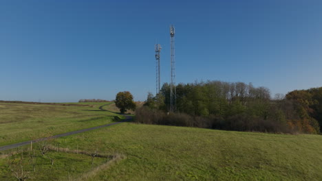 Cellular-towers-in-France-countryside,-aerial-dolly-push-in