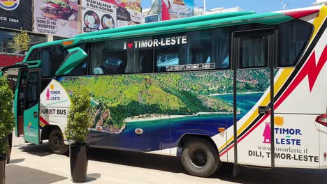 Exterior-view-of-Timor-Leste-tour-bus-with-cruise-ship-passengers-in-the-capital-city-of-Dili,-East-Timor,-Southeast-Asia