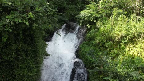 Overgrown-waterfall-in-Balinese-jungle,-Indonesia.-Aerial